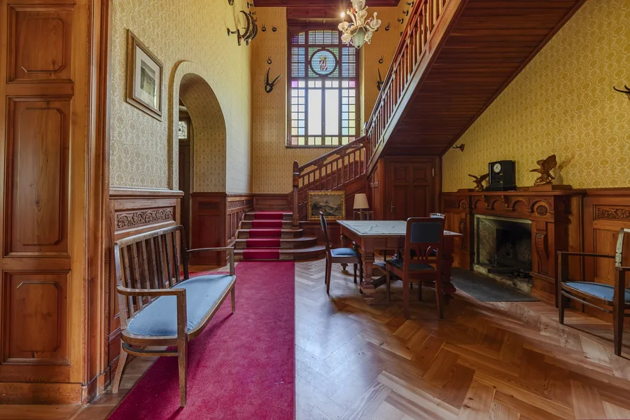 Hall with staircase and fireplace in Villa Laubenò, Gressoney-Saint-Jean, Engel & Völkers